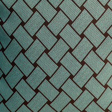 Closeup of front of Bella blue cushion cover with woven pattern in blue and dark brown