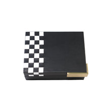 Top of black Campbell box with white checkered pattern on the side and gold hardware