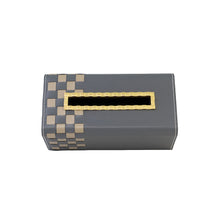 Top of grey Campbell tissue box with beige checkered pattern and indented gold opening