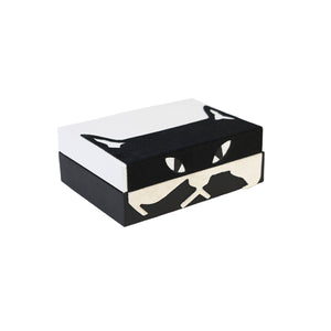 Side of Carson box showing a black and white cat face design and furry texture of design