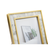 Detailed view of white & gold photoframe 