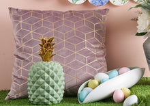 Bardot pink cushion with Arezzo white and green plate and Pineapple green figurine in an Easter-themed shoot