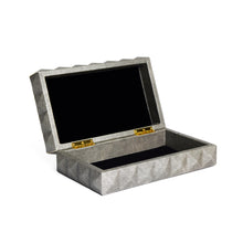 Side view of open Covina box with moulded stud pattern on light grey faux leather, gold hardware and black suede inner lining