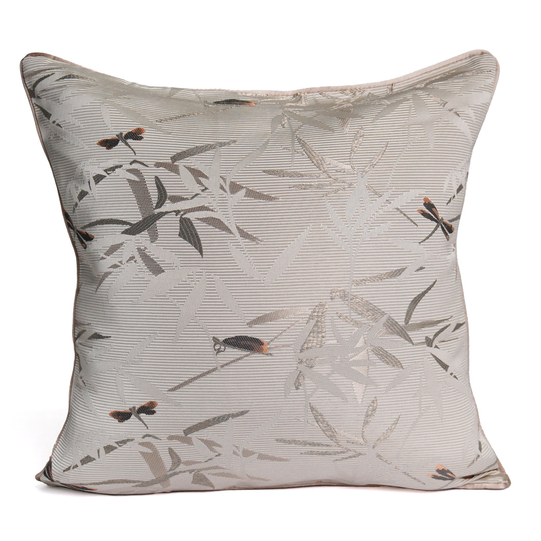Front of Ansan cushion cover with dragonfly and bamboo motifs on a pinstriped light beige base