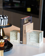Styled photo of Abbey Bookends holding up books on a white dining table