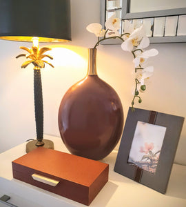 Berlin brown box with Costa black lamp, Lanester maroon vase on a white side console