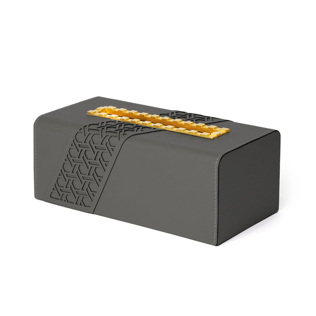 Side view of Tatum tissue box with geometric pattern on dark grey faux leather and yellow indented metal opening