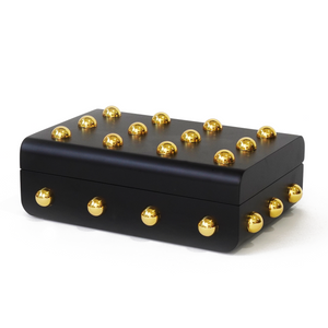 Side view of Velletri box with a smooth black body and decorative gold spherical hardware